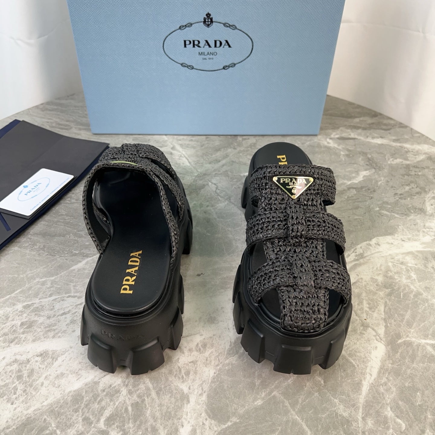 PRADA 25S MONOLITH RUBBER MULES IN BLACK RAFFIA AND LAMBSKIN