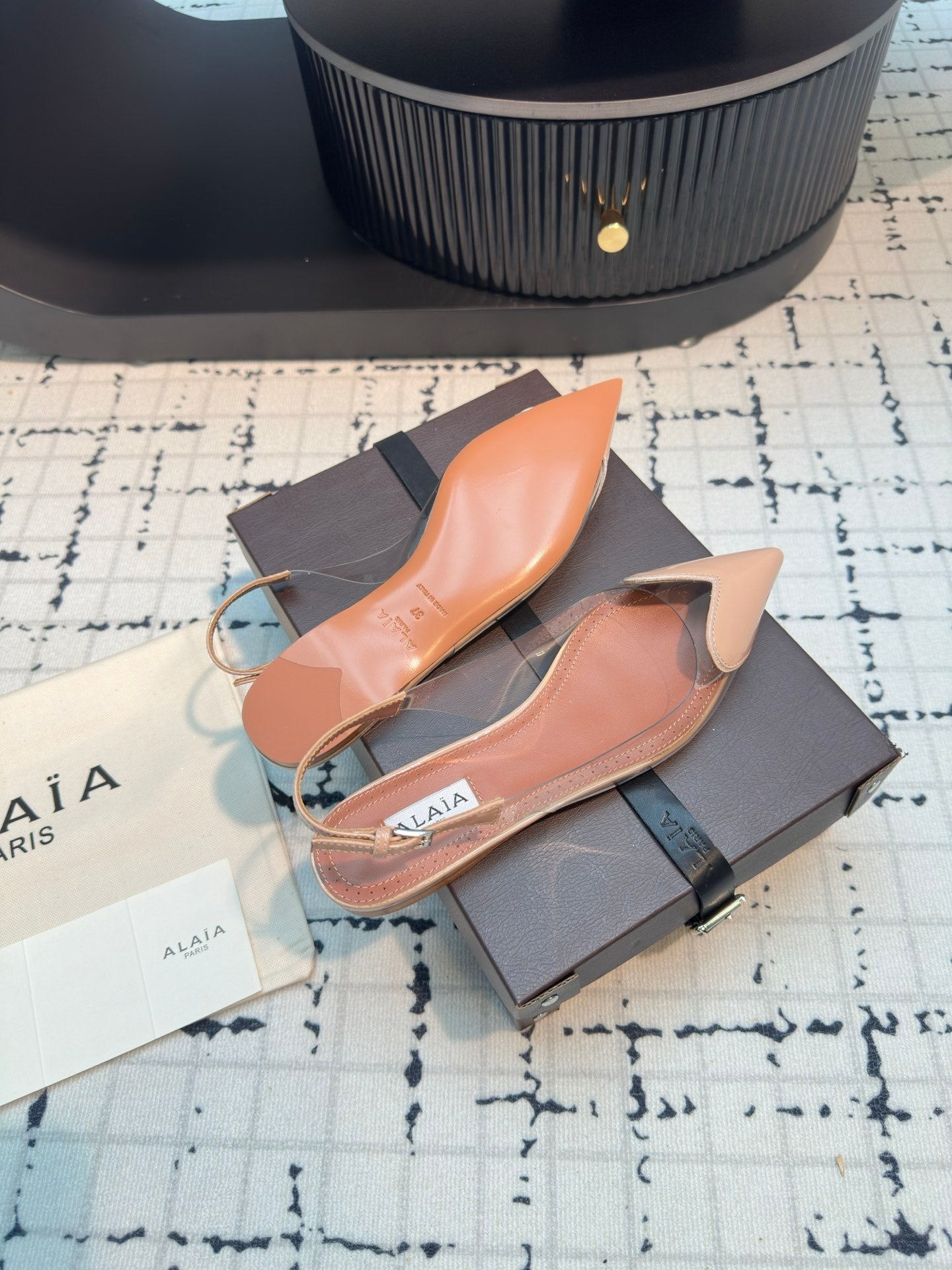 ALAIA FLAT SLINGBACK IN BEIGE BISQUE PATENT CALFSKIN AND FILM