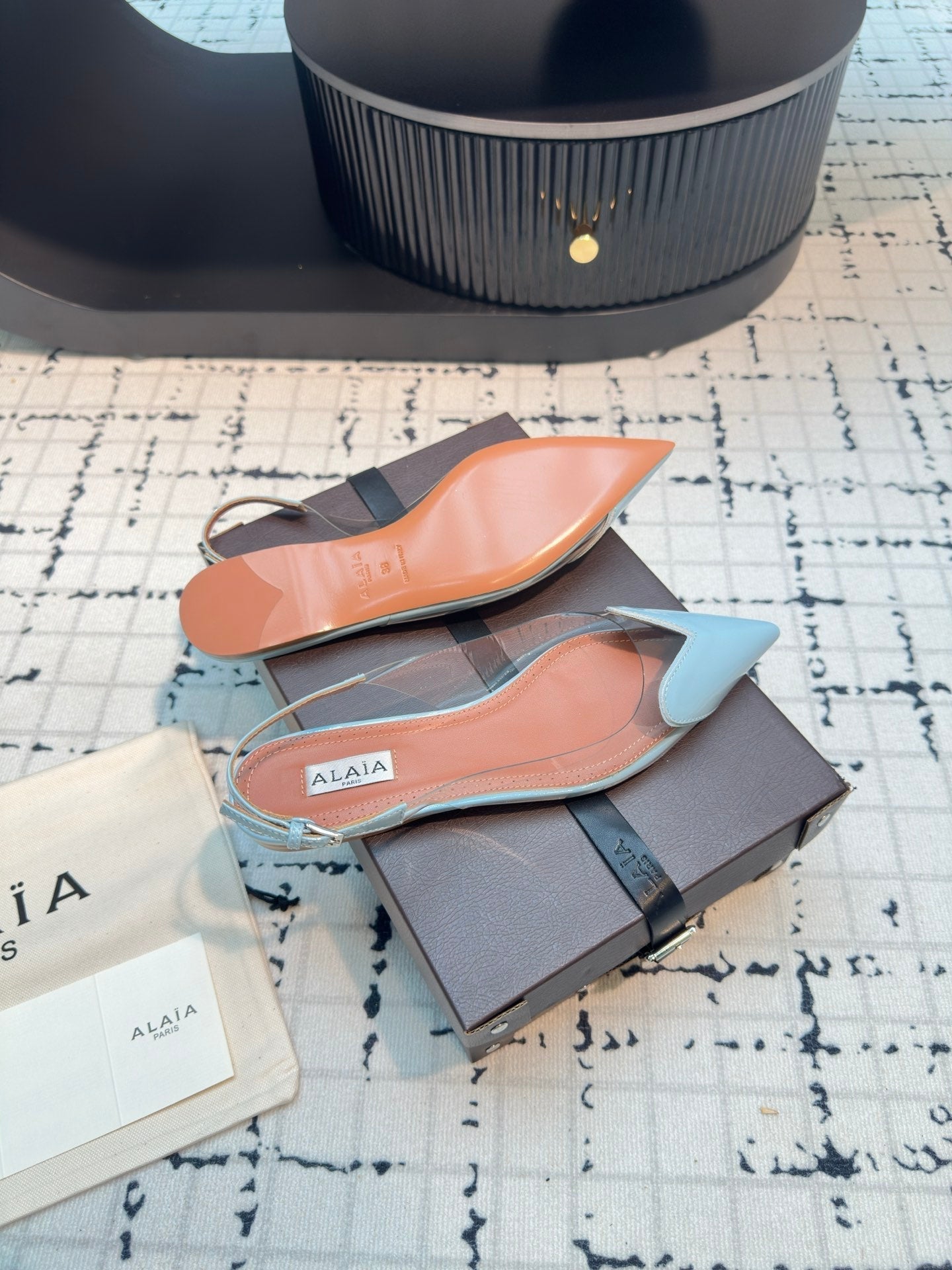 ALAIA FLAT SLINGBACK IN LIGHT BLUE PATENT CALFSKIN AND FILM