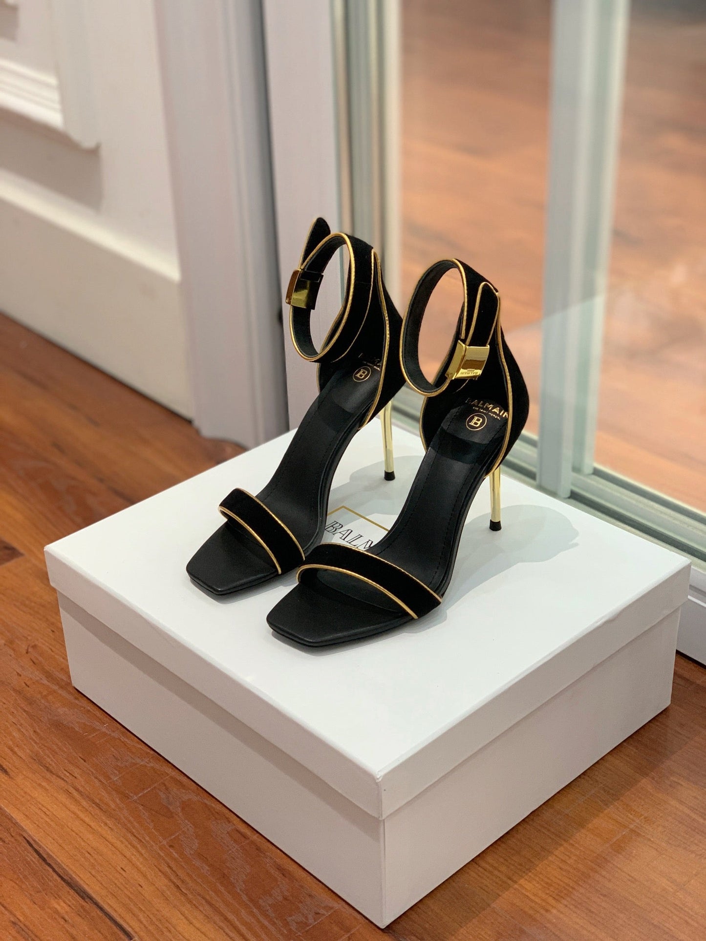 BALMAIN 25S UMA HEELED SANDALS 105MM IN BLACK SUEDE GOLD HARDWARE