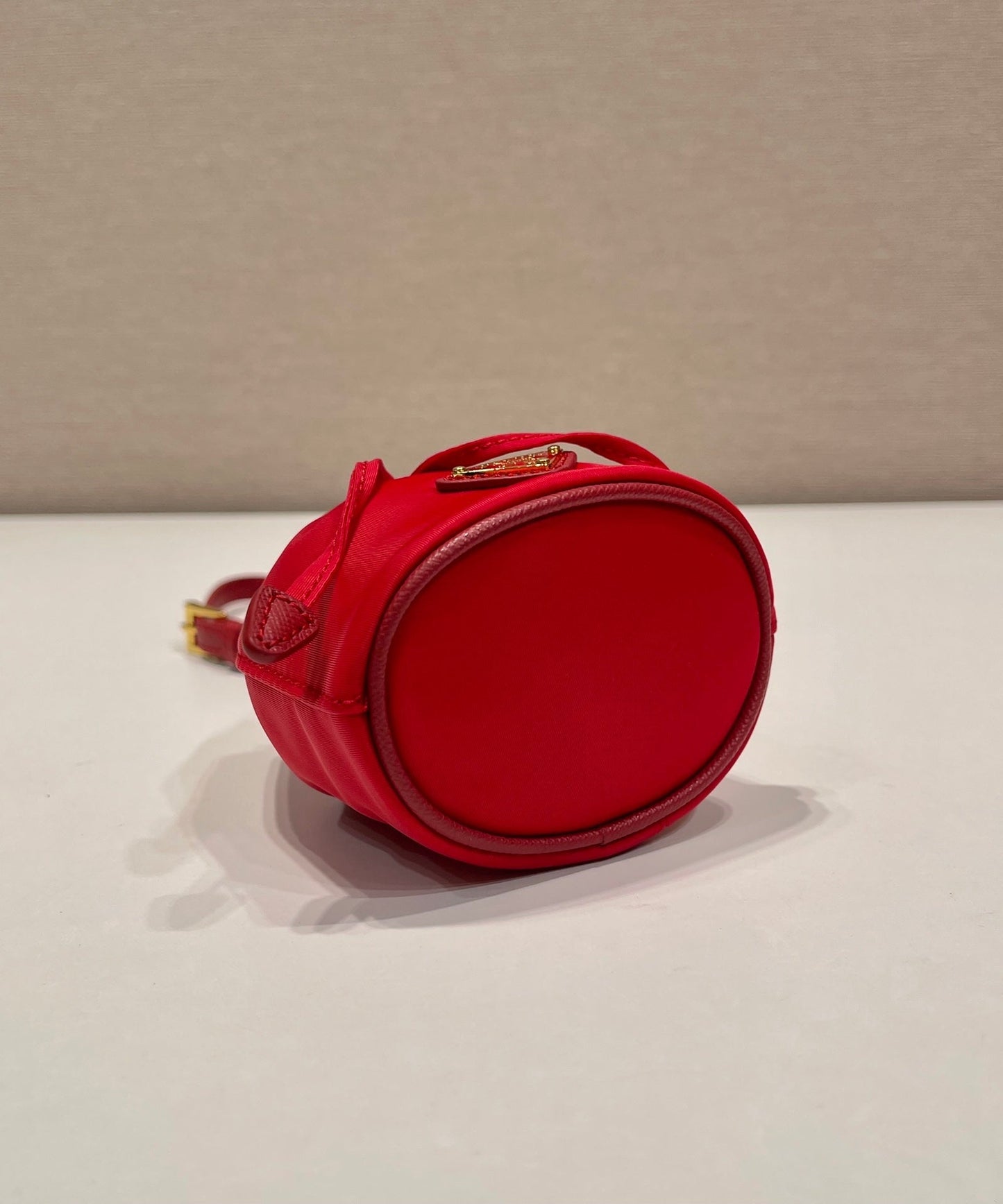 MINI BUCKET BAG 10 IN RED RE-NYLON AND SAFFIANO LEATHER STRAP