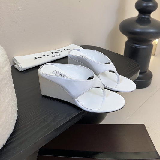 ALAIA WEDGE THONG SANDALS 25S IN WHITE SATIN