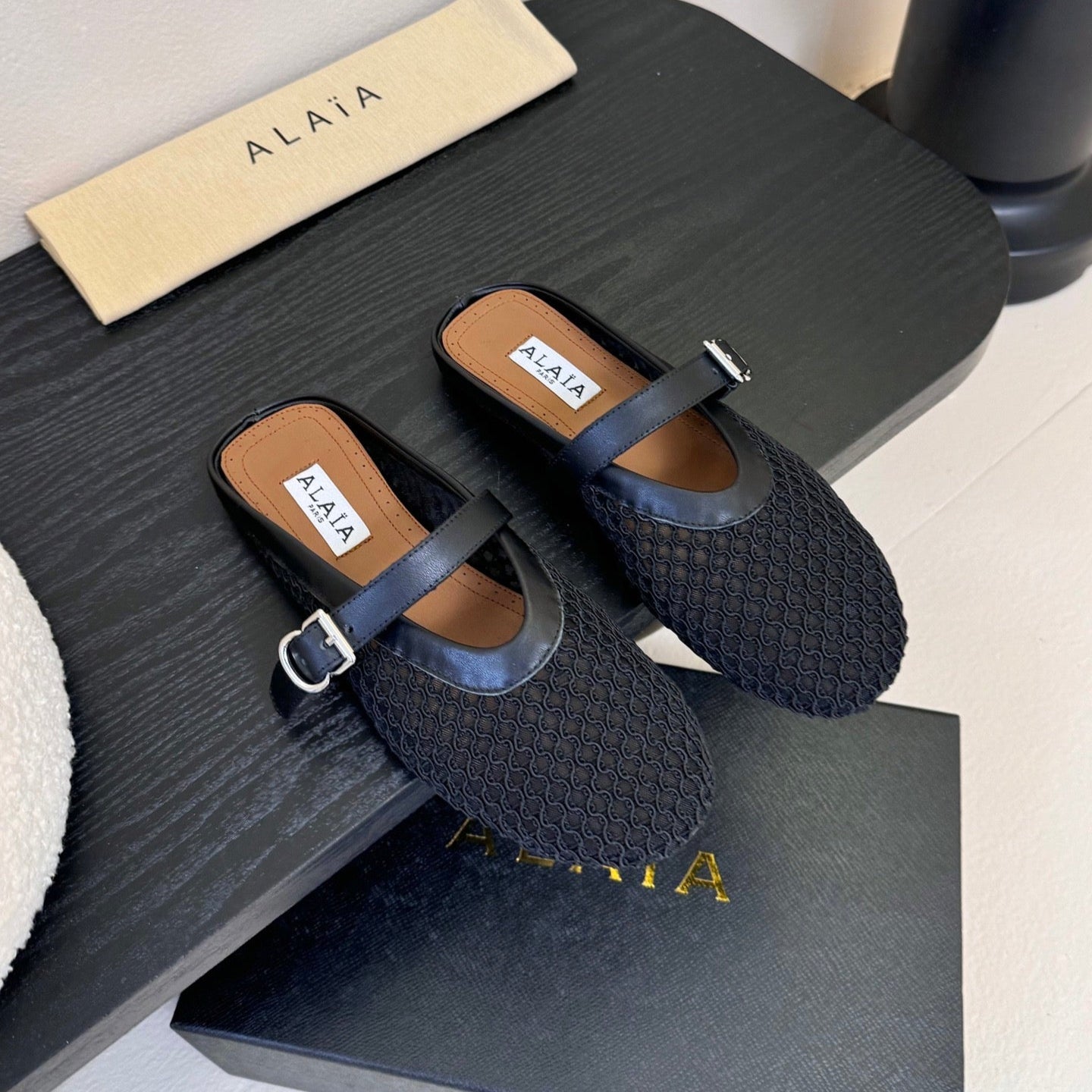 ALAIA FLAT MULES 25S IN BLACK WOVEN MESH
