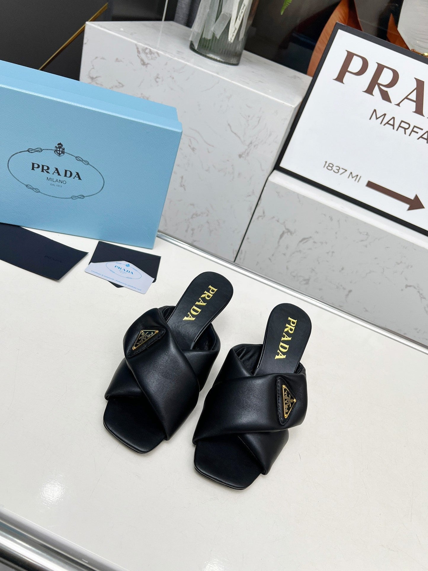 PRA CROSS MULE HEELS IN BLACK CALFSKIN WITH PADDED STRAPS