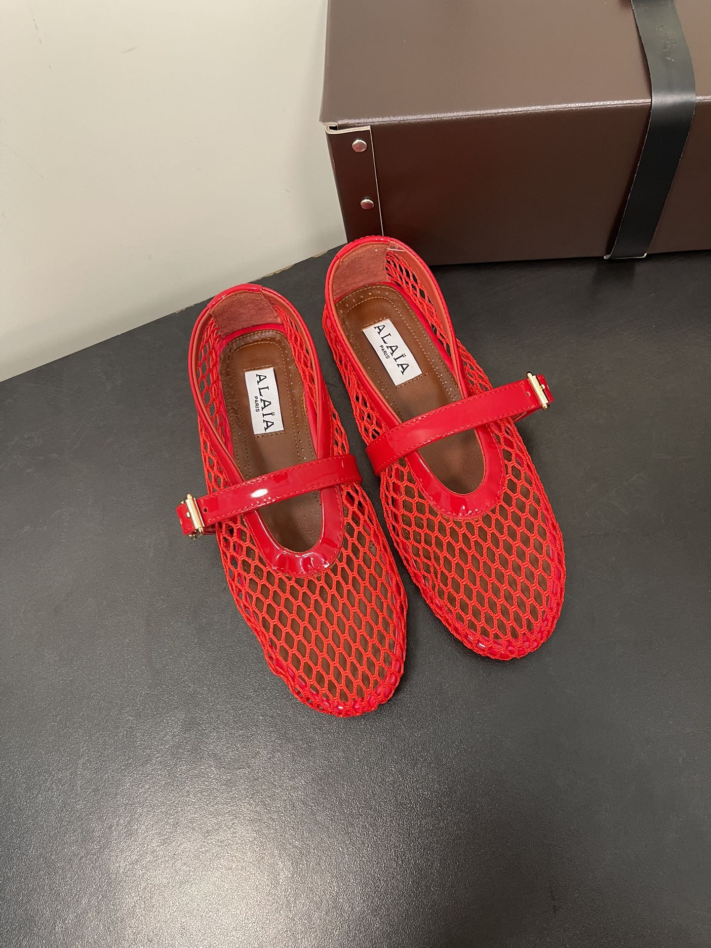 ALAIA BALLET FLATS IN CHERRY RED MESH FISHNET