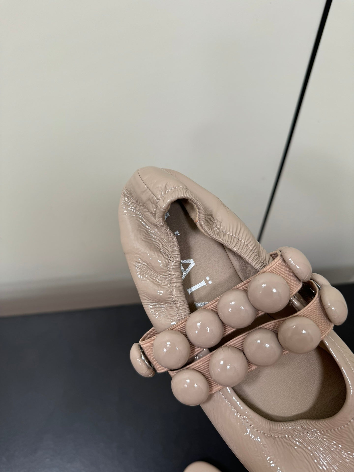 ALAIA SPHERE BALLET FLATS IN ALMOND BEIGE LAMBSKIN