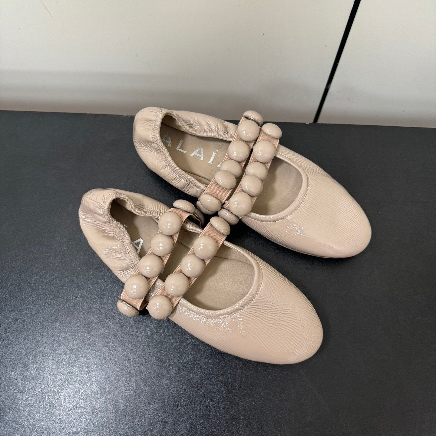 ALAIA SPHERE BALLET FLATS IN ALMOND BEIGE LAMBSKIN