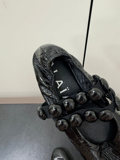 ALAIA SPHERE BALLET FLATS IN BLACK LAMBSKIN