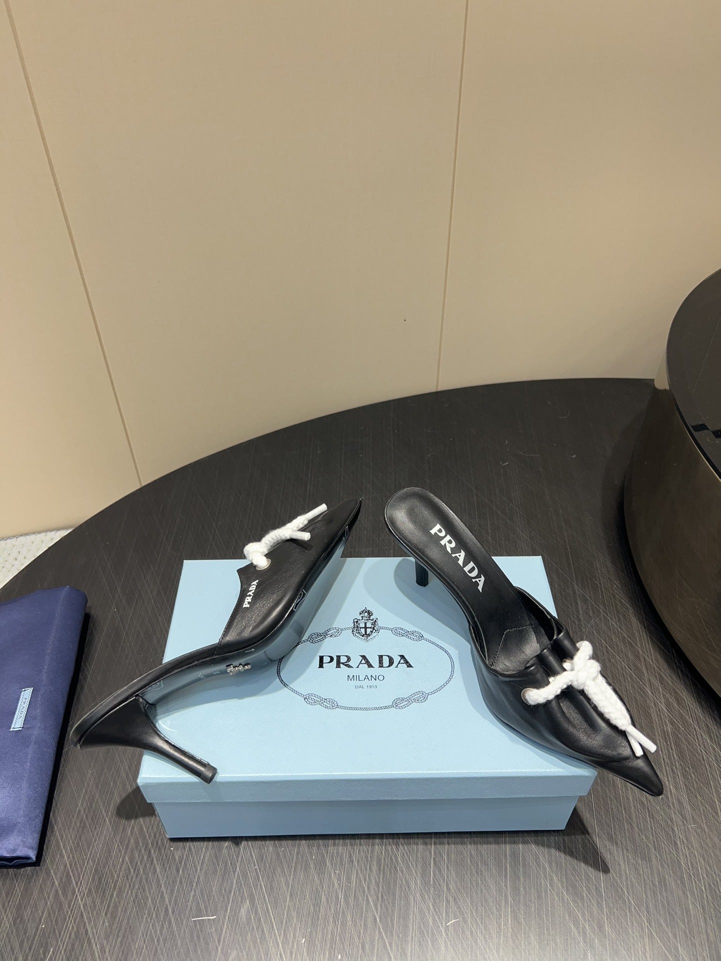 PRADA 25S BRAIDED DETAIL MULES 85MM IN BLACK CALFSKIN