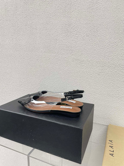 ALAIA LE COEUR FLAT SLINGBACKS IN BLACK PATENT LAMBSKIN