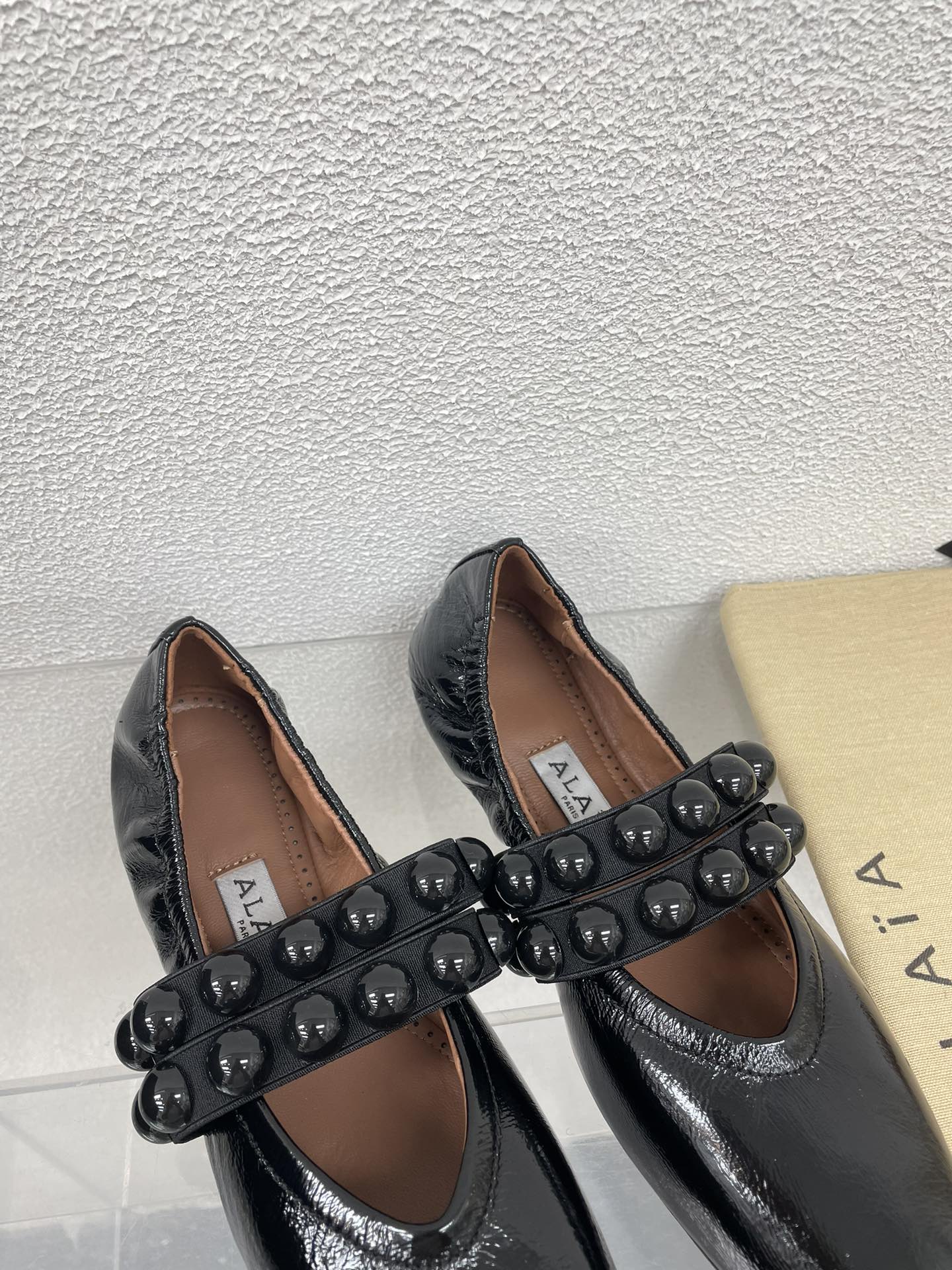 ALAIA MARY JANE PEARL IN GLOSSY BLACK LAMBSKIN