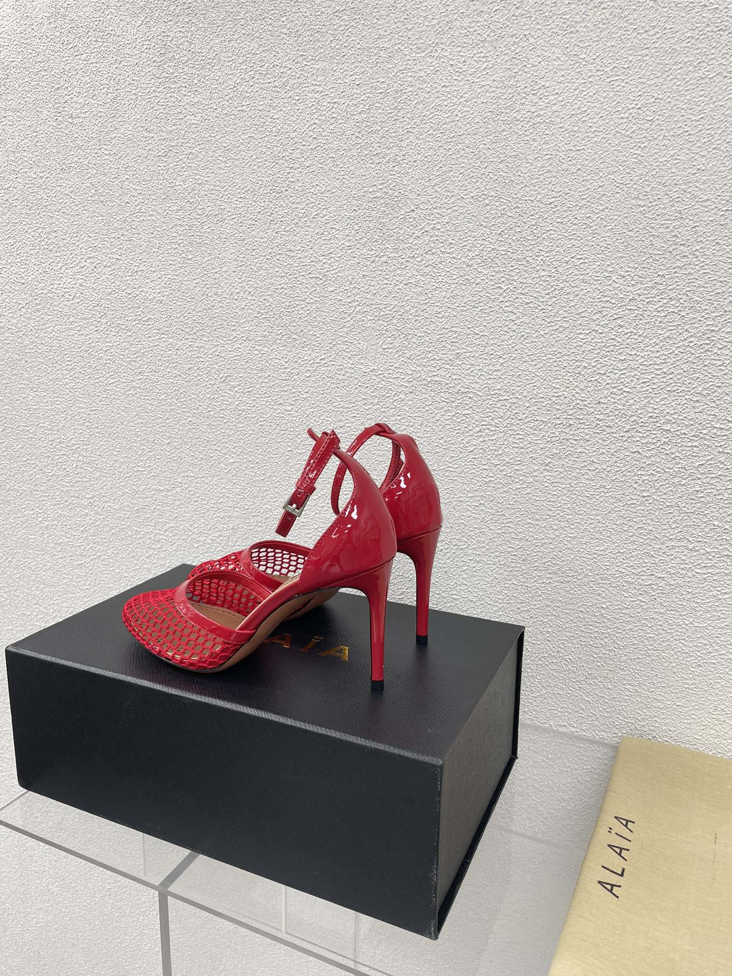 ALAIA HIGH FISHNET 9 CM PUMPS IN CHERRY RED MESH