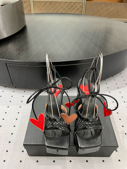 ALAIA BANQUET WEDGE SANDALS IN BLACK LAMBSKIN WITH RED HEART