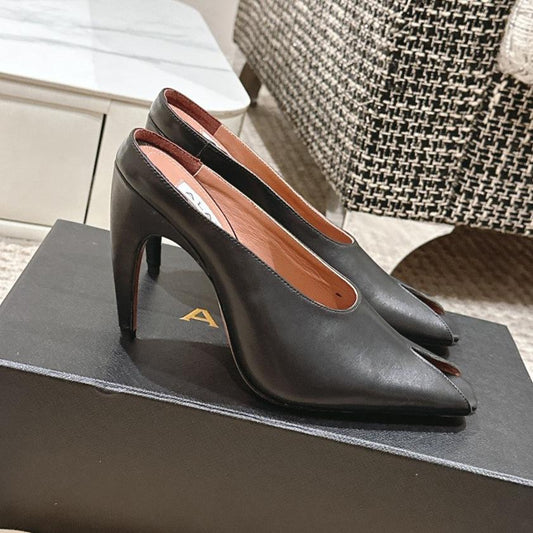 ALAIA SPIKE JEWEL MULES IN BLACK CALFSKIN