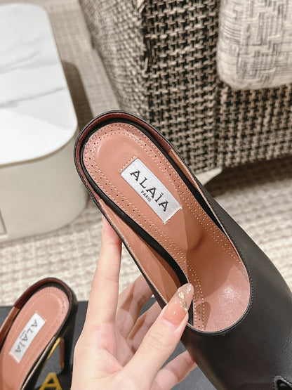 ALAIA SPIKE JEWEL MULES IN BLACK CALFSKIN