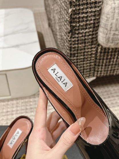 ALAIA SPIKE JEWEL MULES IN BLACK GLOSSY CALFSKIN