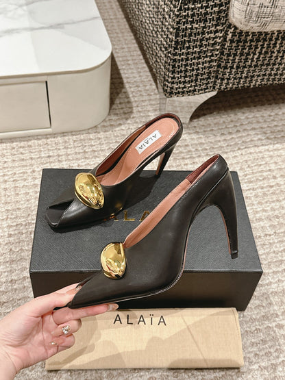 ALAIA SPIKE JEWEL MULES IN BLACK CALFSKIN WITH GOLD HARDWARE