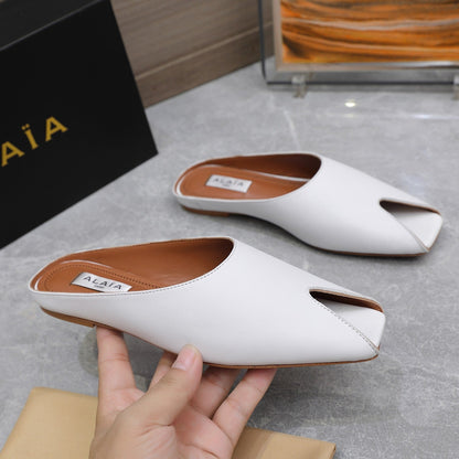 ALAIA FLAT MULE IN WHITE LAMBSKIN