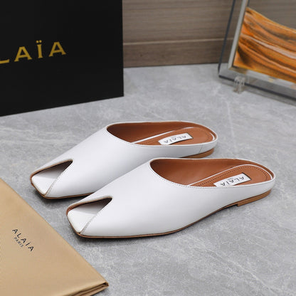 ALAIA FLAT MULE IN WHITE LAMBSKIN