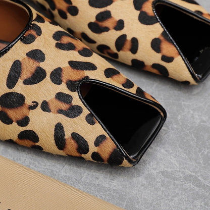 ALAIA FLAT MULE IN LEOPARD LAMBSKIN
