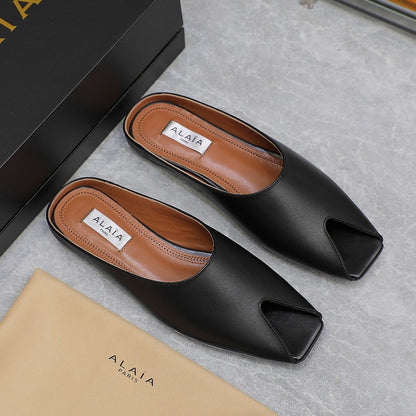 ALAIA FLAT MULE IN BLACK LAMBSKIN