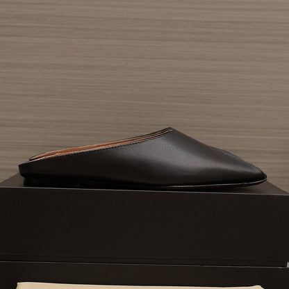 ALAIA FLAT MULE IN BLACK LAMBSKIN