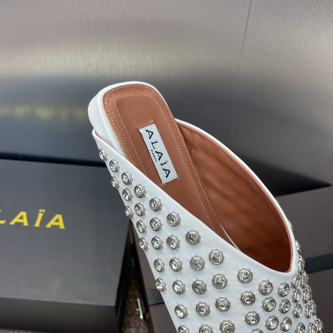 ALAIA FLAT MULES 25S IN WHITE LAMBSKIN EMBELLISHED WITH CRYSTALS
