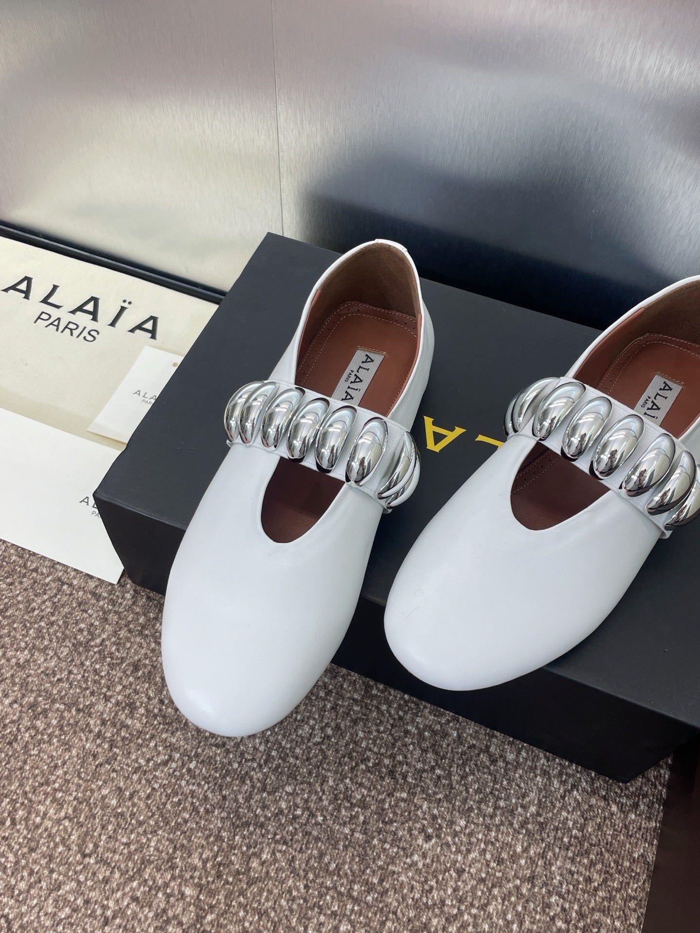 ALAIA MARY JANE FLATS 25S IN WHITE CALFSKIN WITH SILVER HARDWARE