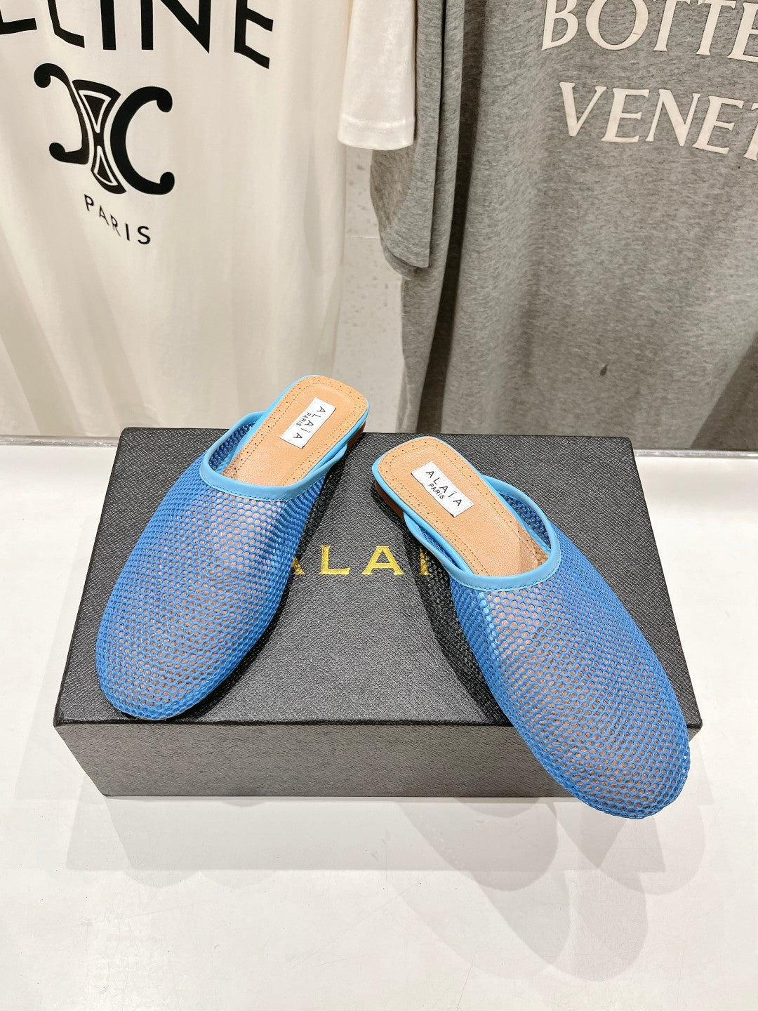 ALAIA FLAT MULES IN CERULEAN BLUE MESH FISHNET