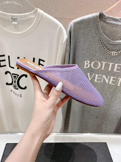 ALAIA FLAT MULES IN LIGHT PURPLE MESH FISHNET