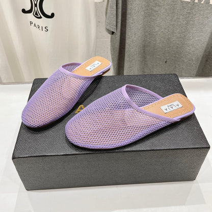 ALAIA FLAT MULES IN LIGHT PURPLE MESH FISHNET