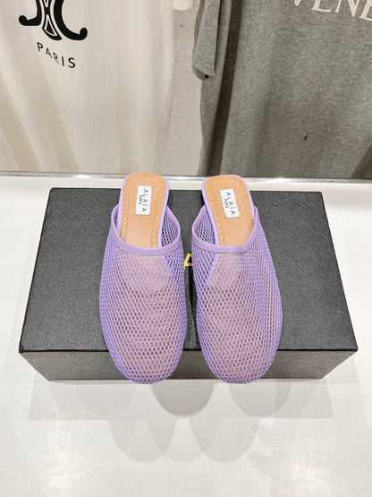 ALAIA FLAT MULES IN LIGHT PURPLE MESH FISHNET